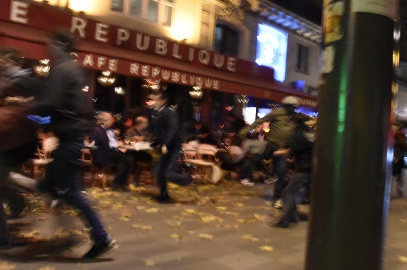 People run after hearing what is believed to be explosions or gun shots near Place de la Republique square in Paris on November 13, 2015. At least 18 people were killed in several shootings and explosions in Paris today, police said. AFP PHOTO / DOMINIQUE FAGET (Photo credit should read DOMINIQUE FAGET/AFP/Getty Images)